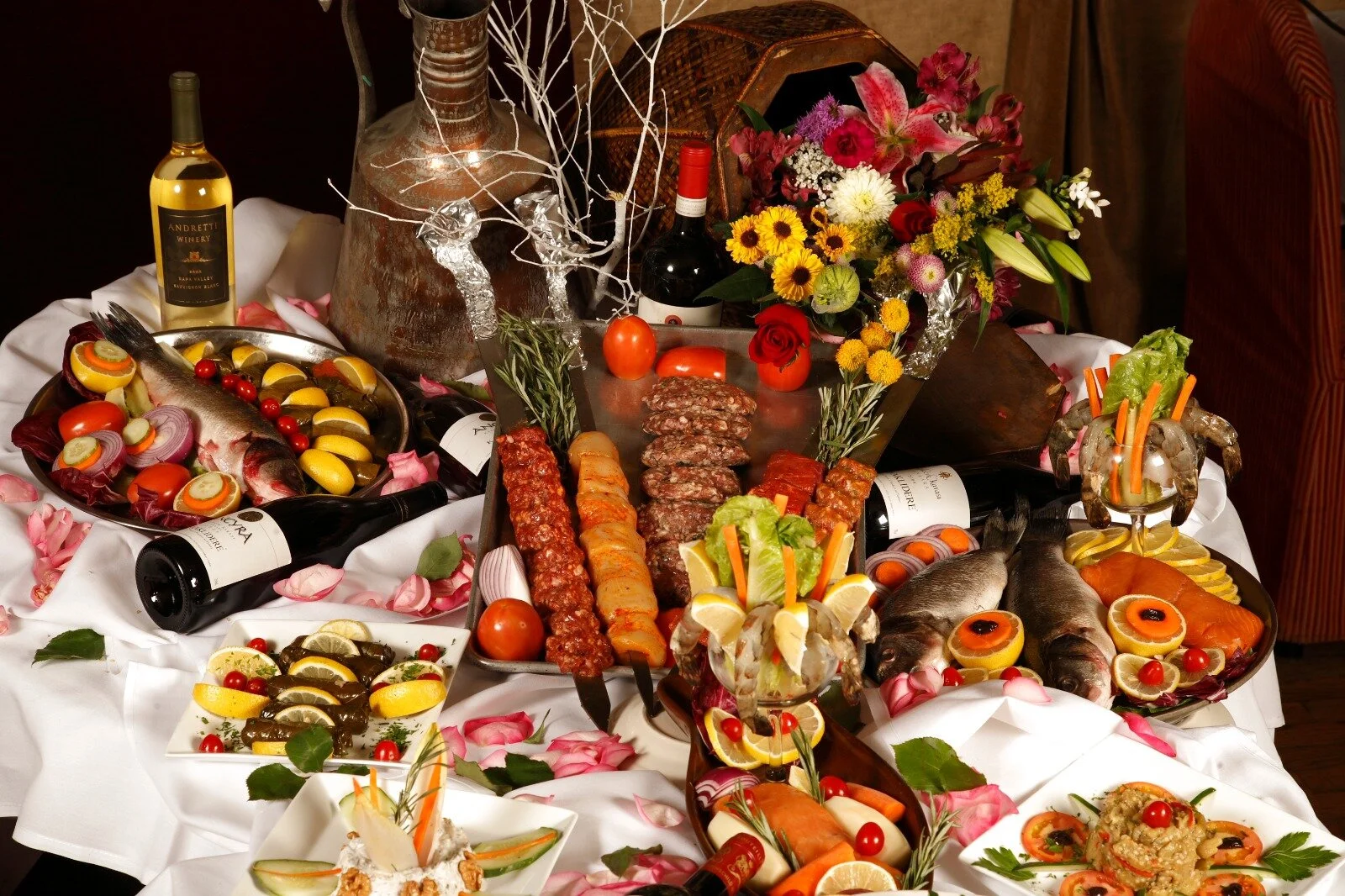 Grand buffet — kebabs, whole fish, wine, fresh flowers