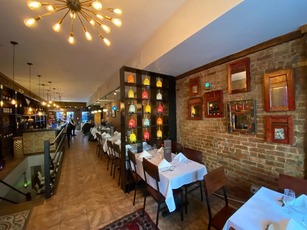 Turkuaz dining room — brick walls and sputnik chandelier